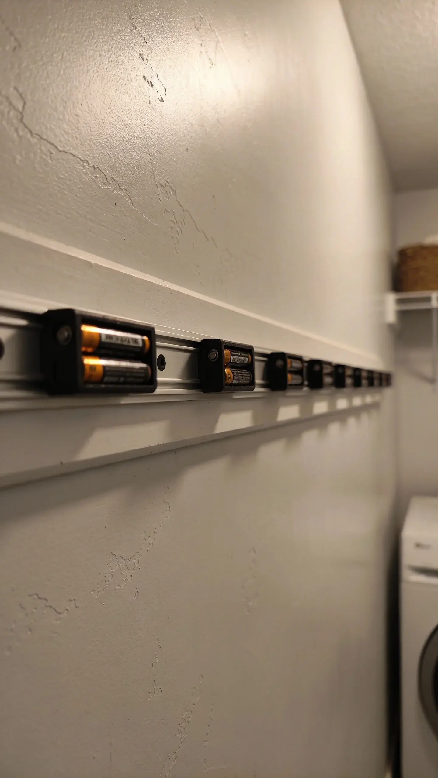 magnetic strip with batteries on laundry room wall