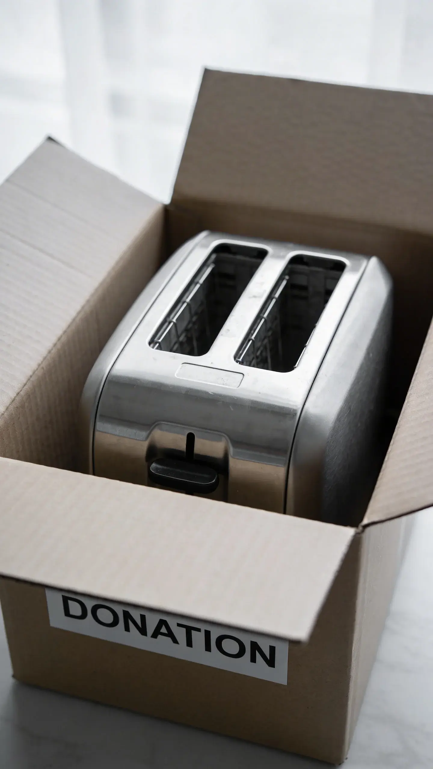 Unused bread maker inside labeled donation box