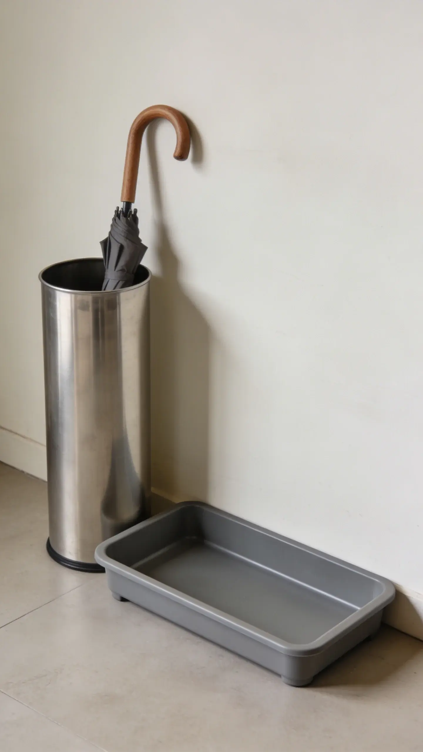 Compact umbrella stand beside low-profile boot tray